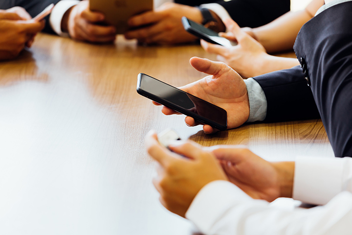 business man using phone while waiting for the app