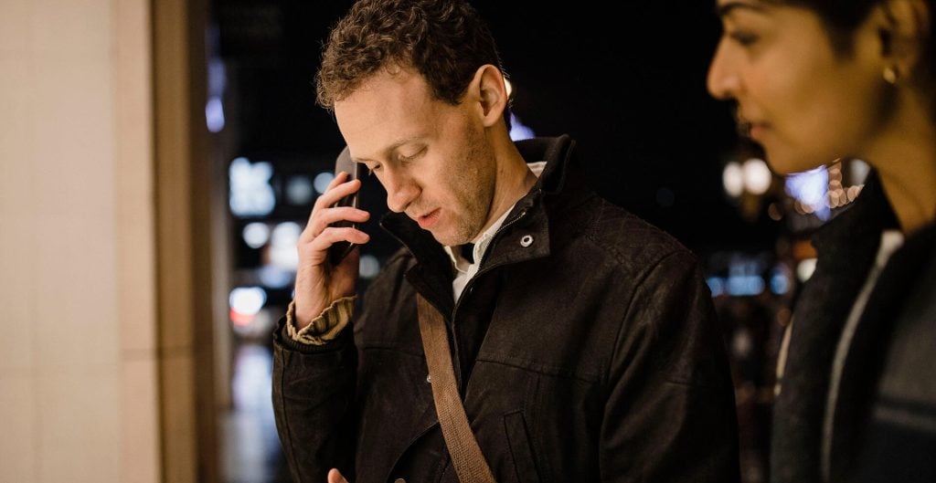 Male with disability interacting with mobile device
